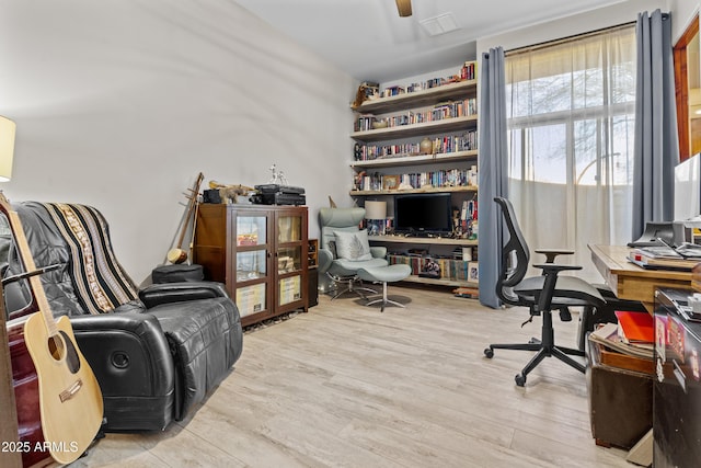 home office with ceiling fan and wood finished floors