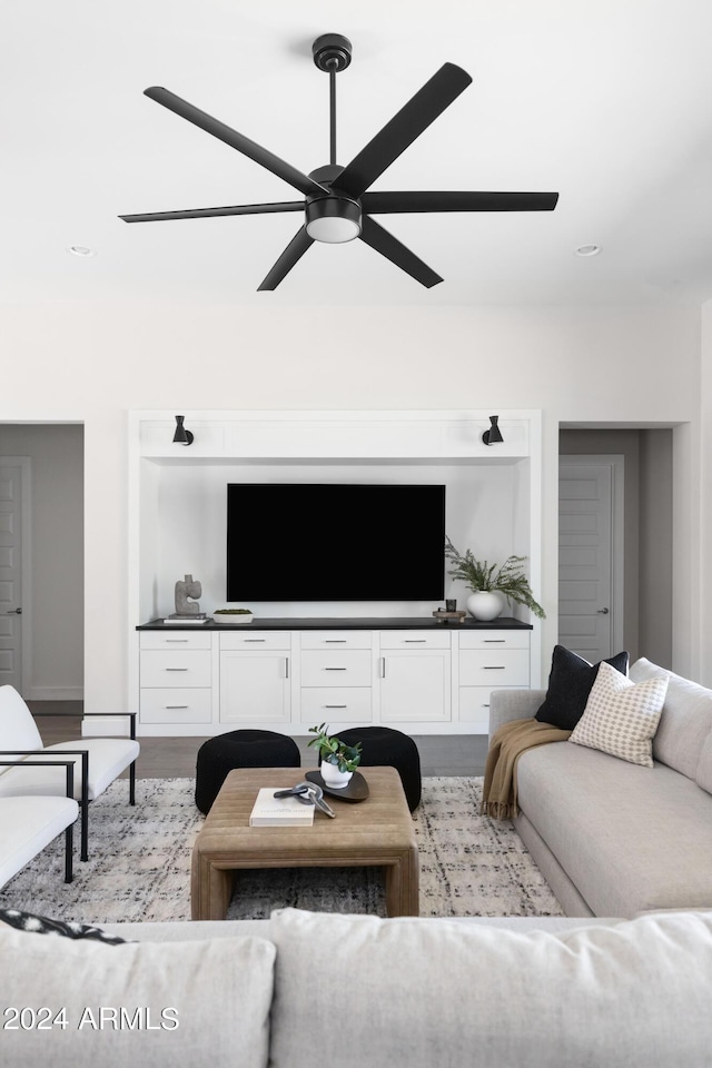 living room with light wood-type flooring and ceiling fan