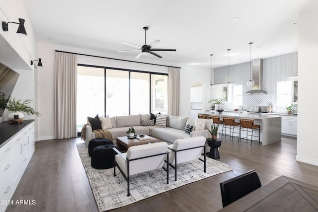 living room featuring dark hardwood / wood-style floors and ceiling fan