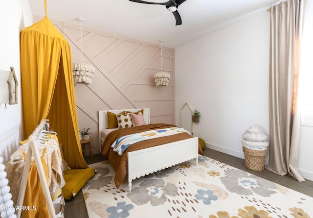 bedroom with ceiling fan and dark wood-type flooring