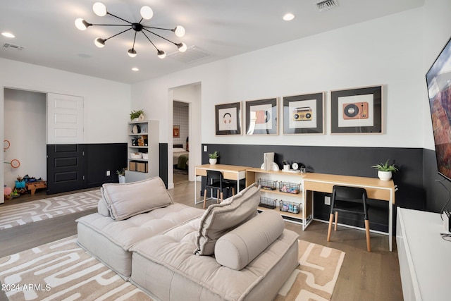 living room with a chandelier and hardwood / wood-style flooring