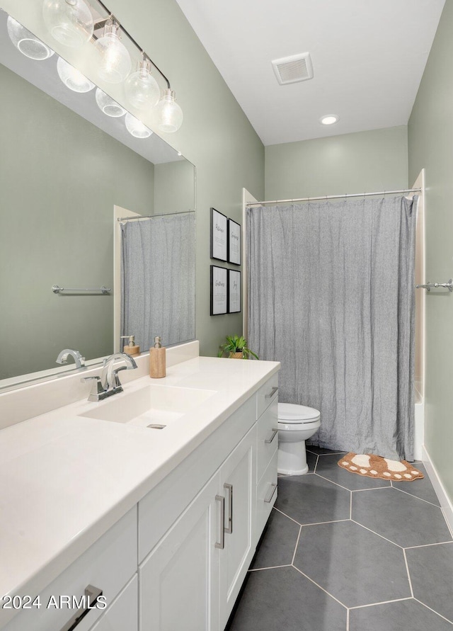 full bathroom featuring tile patterned flooring, vanity, shower / tub combo, and toilet