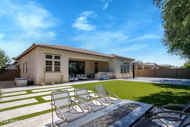 rear view of property featuring a yard, a patio area, and outdoor lounge area