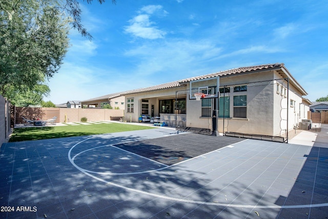 view of basketball court with a lawn