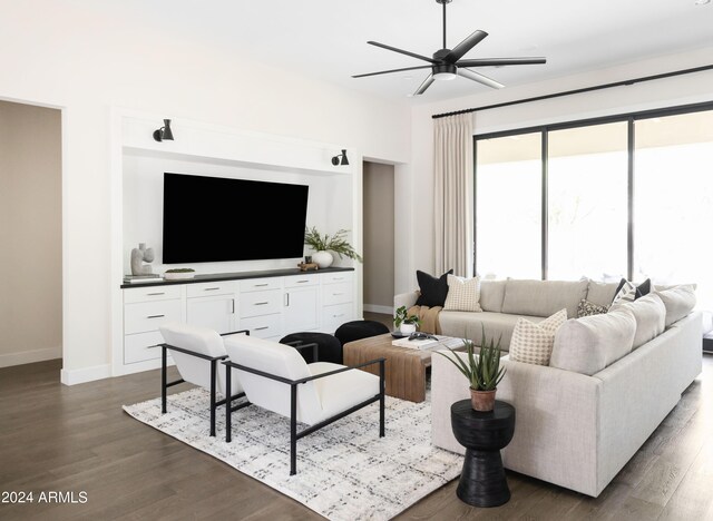 living room with dark hardwood / wood-style flooring and ceiling fan