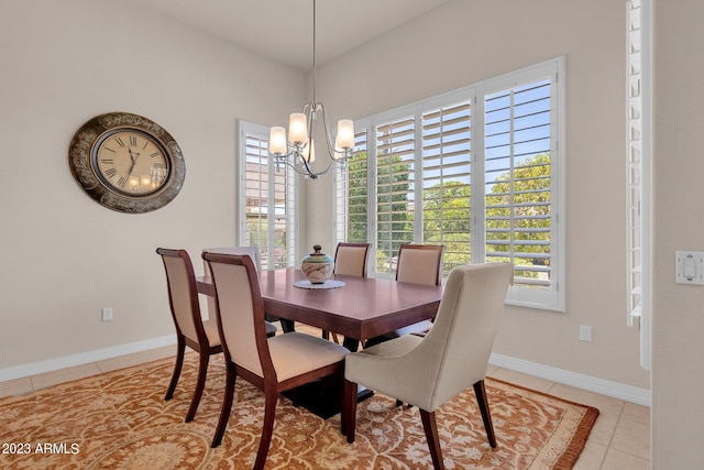 dining room featuring a wealth of natural light, light tile patterned floors, and a chandelier