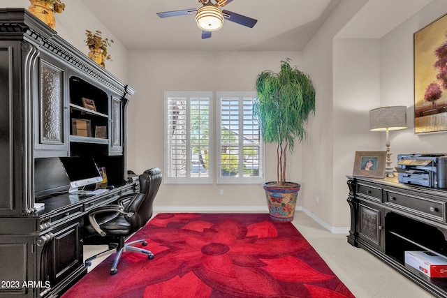 office area with carpet, baseboards, and a ceiling fan