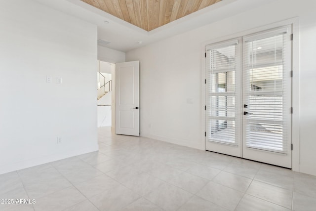 spare room with wood ceiling, baseboards, stairs, and light tile patterned flooring
