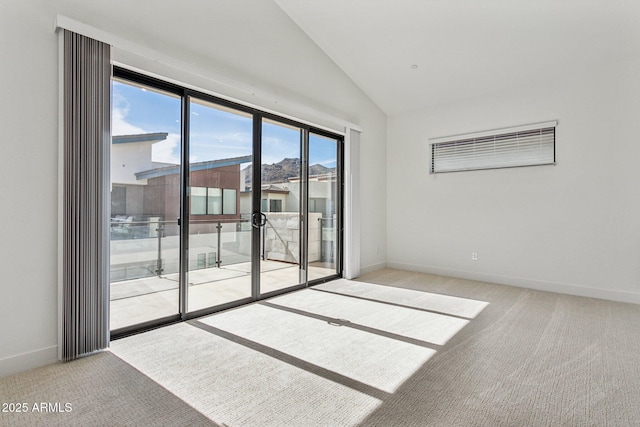 unfurnished room with carpet floors, a wealth of natural light, and lofted ceiling