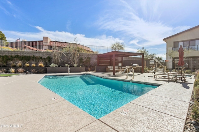 pool with a fenced backyard and a patio