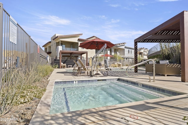 view of pool with a patio area and fence