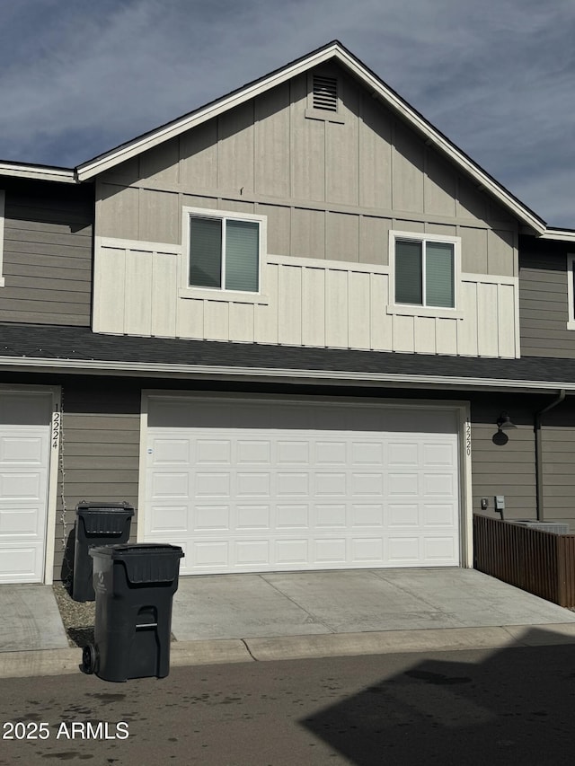 exterior space featuring a garage and roof with shingles