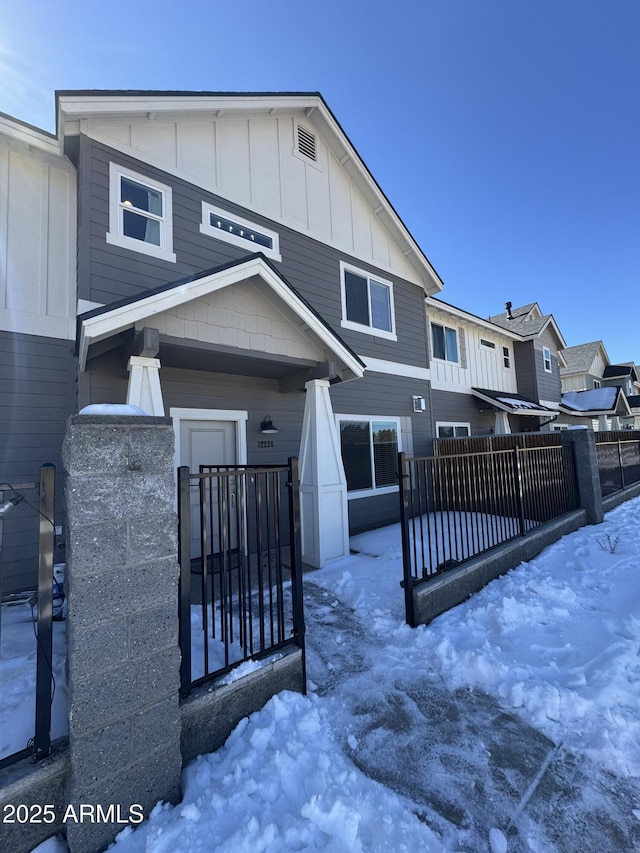 view of front of house with fence and board and batten siding