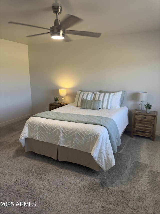 carpeted bedroom with ceiling fan and baseboards