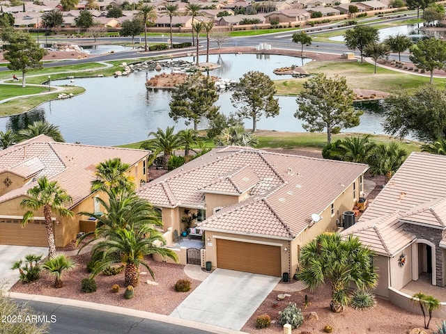 birds eye view of property with a water view and a residential view