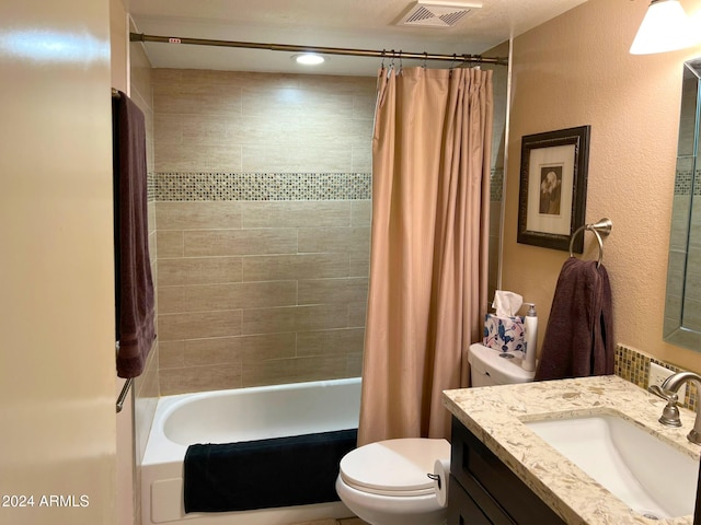 full bathroom with shower / tub combo with curtain, vanity, and toilet