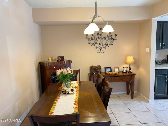 dining area with a chandelier and light tile patterned floors