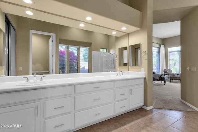 full bath featuring a sink, plenty of natural light, and double vanity