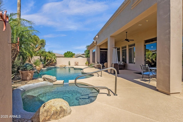 view of pool with a fenced backyard, ceiling fan, a pool with connected hot tub, and a patio area