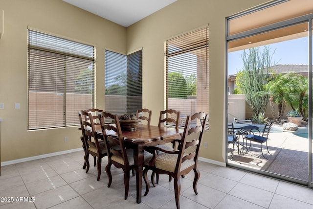 dining area featuring light tile patterned floors, baseboards, and a wealth of natural light