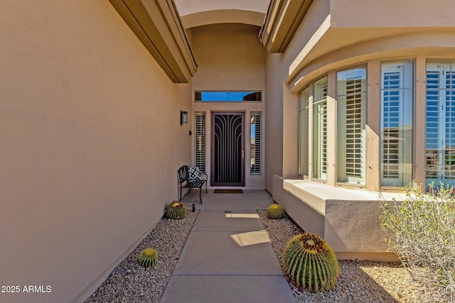 entrance to property featuring stucco siding