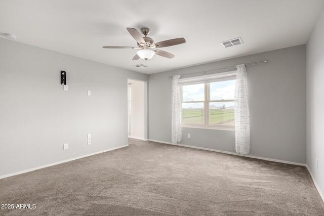 empty room with ceiling fan and carpet