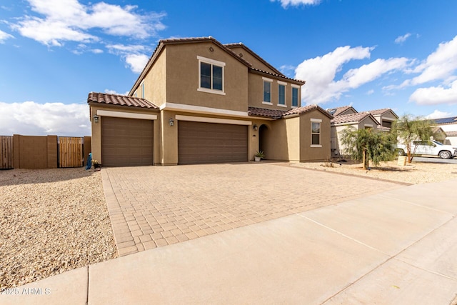 mediterranean / spanish home featuring a garage