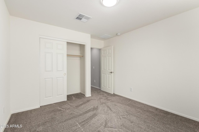 unfurnished bedroom with carpet floors and a closet