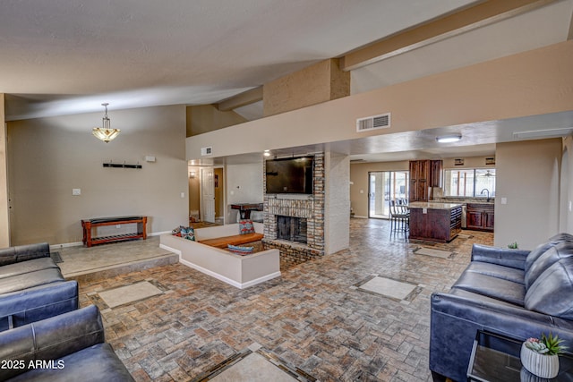 6520 E Peak View Rd, Cave Creek, AZ 85331 - living room featuring a brick fireplace, high vaulted ceiling, and baseboards