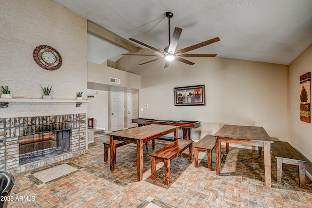 6520 E Peak View Rd, Cave Creek, AZ 85331 - dining area featuring brick flooring, lofted ceiling, a ceiling fan, and a brick fireplace