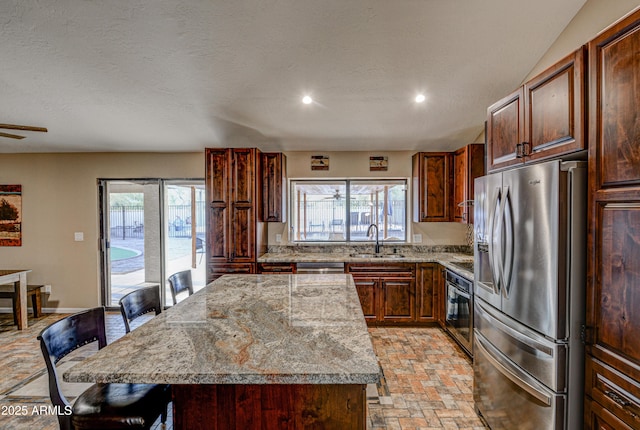 6520 E Peak View Rd, Cave Creek, AZ 85331 - kitchen featuring appliances with stainless steel finishes, a sink, a kitchen breakfast bar, healthy amount of natural light, and recessed lighting
