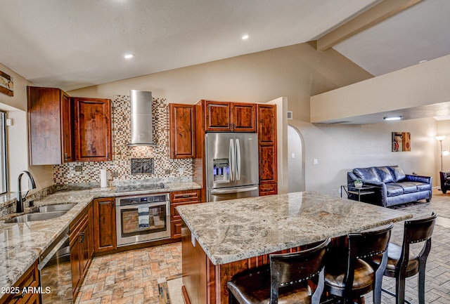 6520 E Peak View Rd, Cave Creek, AZ 85331 - kitchen featuring appliances with stainless steel finishes, a sink, wall chimney exhaust hood, light stone countertops, and a kitchen bar