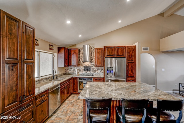 6520 E Peak View Rd, Cave Creek, AZ 85331 - kitchen with stainless steel appliances, a sink, a center island, light stone counters, and arched walkways