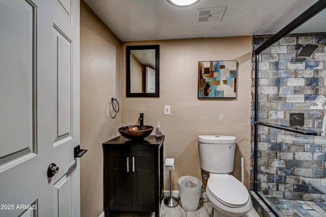 6520 E Peak View Rd, Cave Creek, AZ 85331 - full bathroom with a shower stall, toilet, vanity, baseboards, and a textured wall