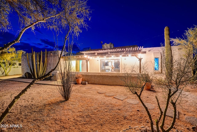 6520 E Peak View Rd, Cave Creek, AZ 85331 - back of house at twilight featuring stucco siding