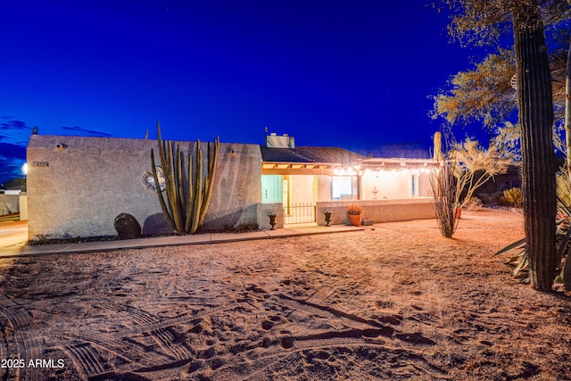 6520 E Peak View Rd, Cave Creek, AZ 85331 - back of house at night with stucco siding