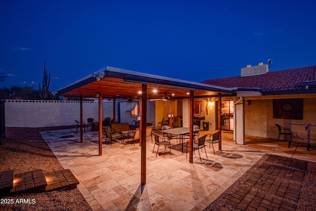 6520 E Peak View Rd, Cave Creek, AZ 85331 - patio at twilight with outdoor dining area, fence, and ceiling fan