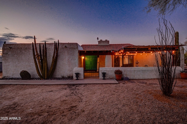 6520 E Peak View Rd, Cave Creek, AZ 85331 - pueblo-style home featuring a chimney, a tiled roof, and stucco siding