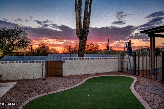 6520 E Peak View Rd, Cave Creek, AZ 85331 - yard at dusk featuring fence and a putting area