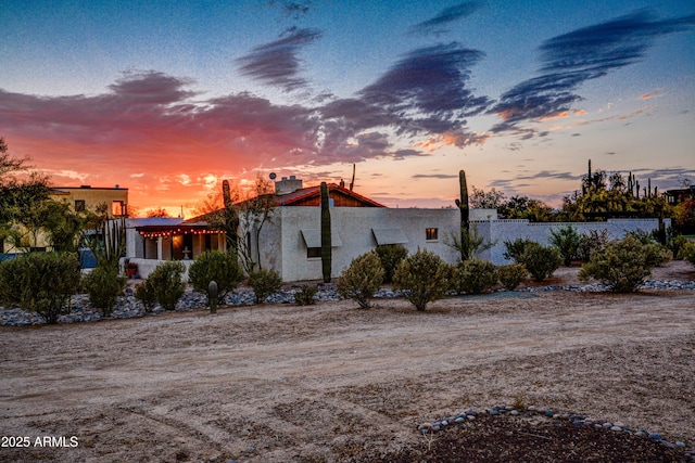 6520 E Peak View Rd, Cave Creek, AZ 85331 - property exterior at dusk featuring stucco siding