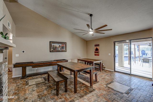 6520 E Peak View Rd, Cave Creek, AZ 85331 - dining area with ceiling fan, lofted ceiling, baseboards, a textured ceiling, and a fireplace