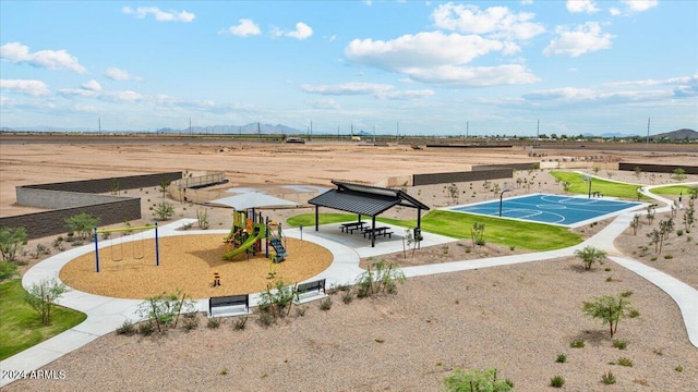 surrounding community featuring a playground and basketball court