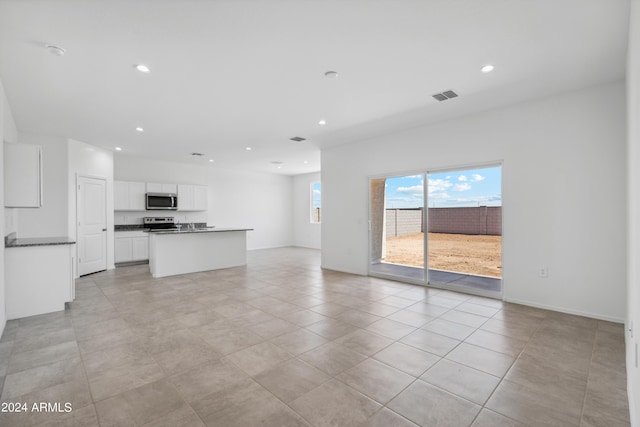 unfurnished living room featuring light tile patterned flooring