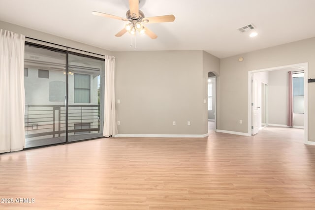 unfurnished room featuring light wood finished floors, visible vents, baseboards, and ceiling fan