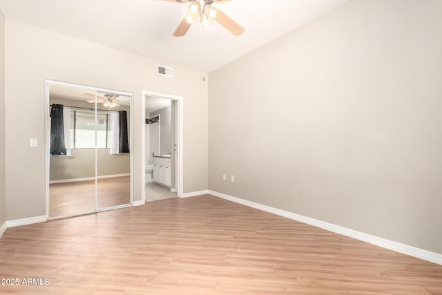 unfurnished bedroom featuring baseboards, visible vents, a closet, and light wood-type flooring