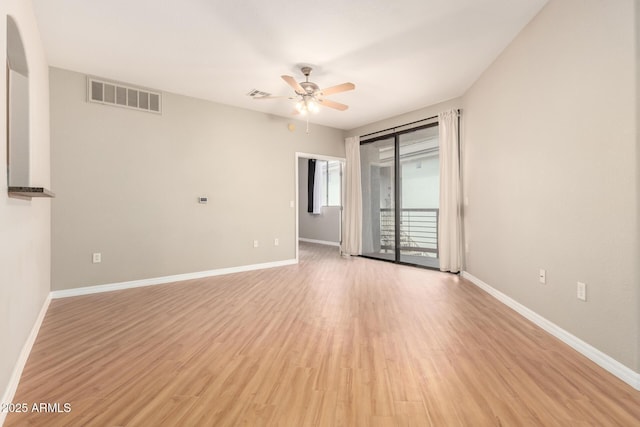 spare room with visible vents, baseboards, a ceiling fan, and light wood finished floors