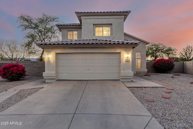 8450 S Stephanie Ln, Tempe, AZ 85284 - mediterranean / spanish home with stucco siding, a garage, concrete driveway, and a tile roof