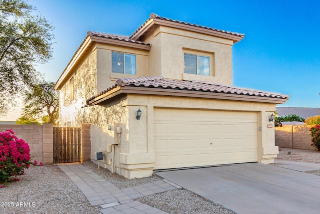 8450 S Stephanie Ln, Tempe, AZ 85284 - mediterranean / spanish home featuring stucco siding, driveway, an attached garage, a gate, and a tiled roof
