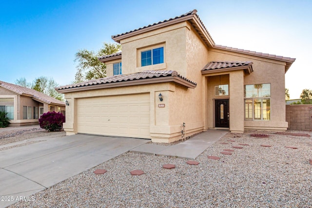 8450 S Stephanie Ln, Tempe, AZ 85284 - mediterranean / spanish house featuring stucco siding, concrete driveway, a tiled roof, and an attached garage