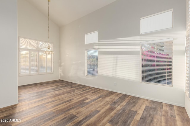 8450 S Stephanie Ln, Tempe, AZ 85284 - spare room with high vaulted ceiling, a chandelier, wood finished floors, and baseboards